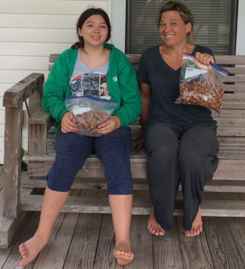 Erin and Madeline with pecans they cracked and shelled